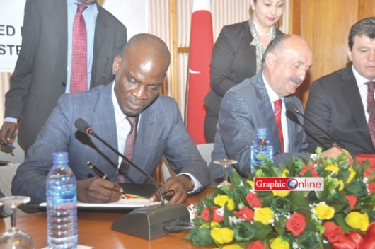 Mr Haruna Iddrisu (left), together with Dr Mehmet Muezzinoglu (right), signing the agreement at a ceremony in Accra.