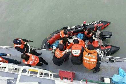 Rescuers aid people on board the sinking South Korean passenger ship. 