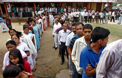 Indian electorates in Assam waiting in line to cast their votes