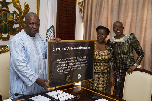 President Mahama displaying a plaque presented to him by the officials of ONE AFRICA, Dr. Sipho Moyo, Director of ONE Africa (middle)  and Madam Nachilala Nkombo, Assistant Director.