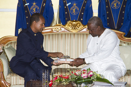 Professor Ortega presents a gift of write-ups about his country to President Mahama