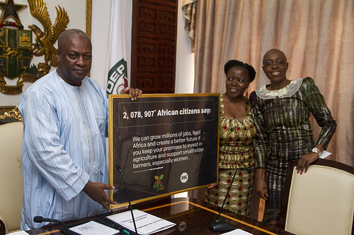 President Mahama displaying a plaque presented to him by the officials of ONE AFRICA, Dr. Sipho Moyo, Director of ONE Africa (middle) and Madam Nachilala Nkombo, Assistant Director.